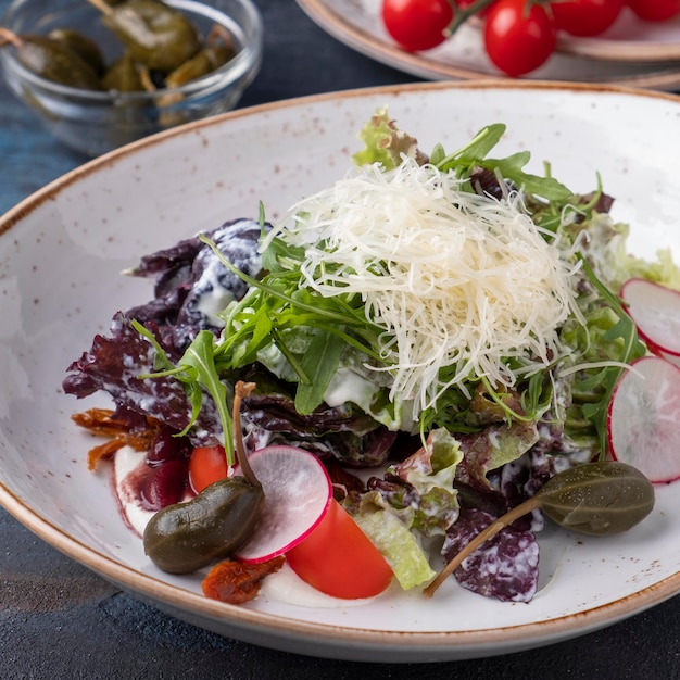 Diet salad with radish tomatoes lettuce and cheese