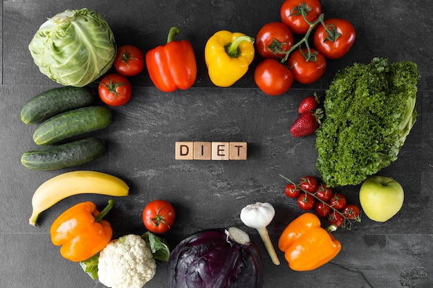 Diet text near healthy food on dark wooden background top view