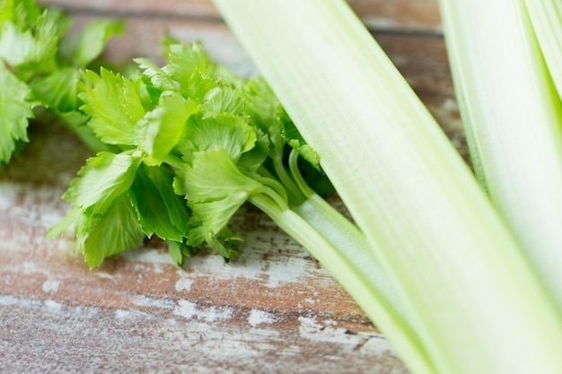 diet, vegetable food, cooking and objects concept - close up of celery stems on wooden table