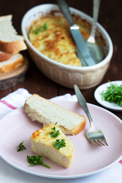 Dietary souffle of minced meat with parsley on a dark background.