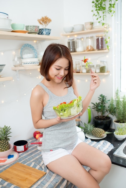 Dieting concept. Healthy Food. Beautiful Young Woman Eating Vegetable Salad In Bowl.