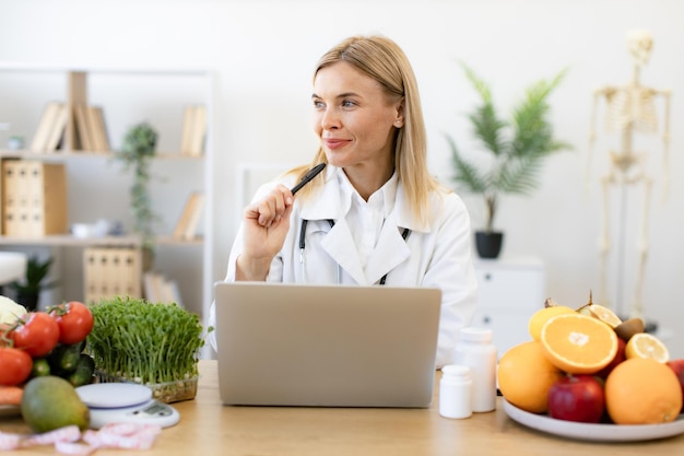 Photo dietitian working with laptop computer making balanced corrective diet plan