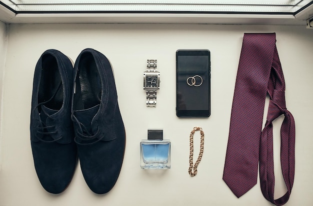 Different accessories of a businessman for creating a style of a people lie on a wooden background