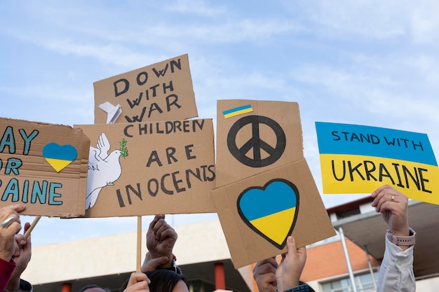 Different banners at the protest demonstration against the Russian invasion Sign of peace not war and messages of solidarity and support for the Ukrainian people