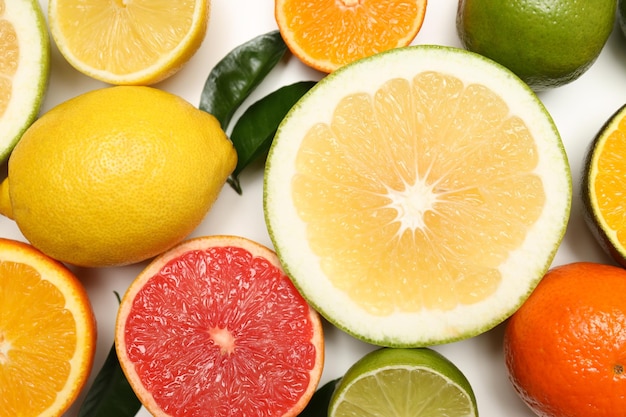 Different citrus fruits on white background close up