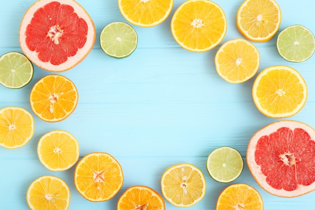 Different citrus and juicy slices on a colored background place to insert text