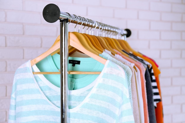 Different clothes on hangers close up