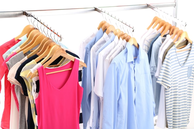 Different clothes on hangers on gray background