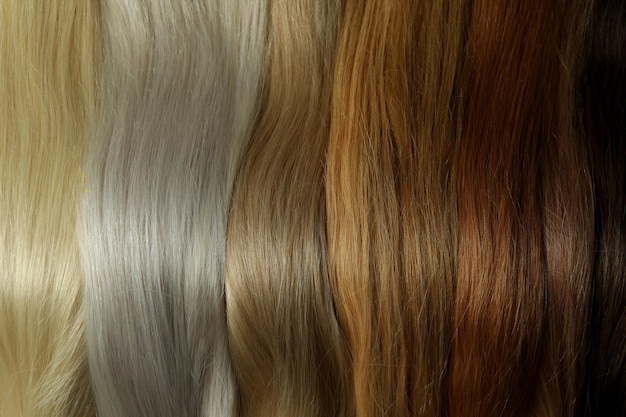 Different color female hair on whole background, close up