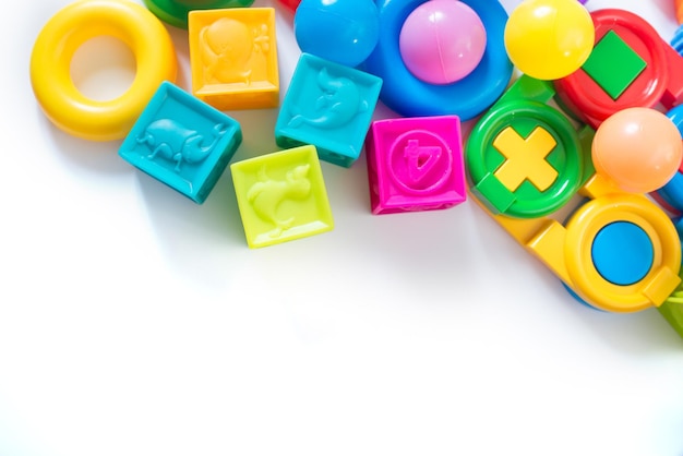 Different colored children toys, cubes on white background