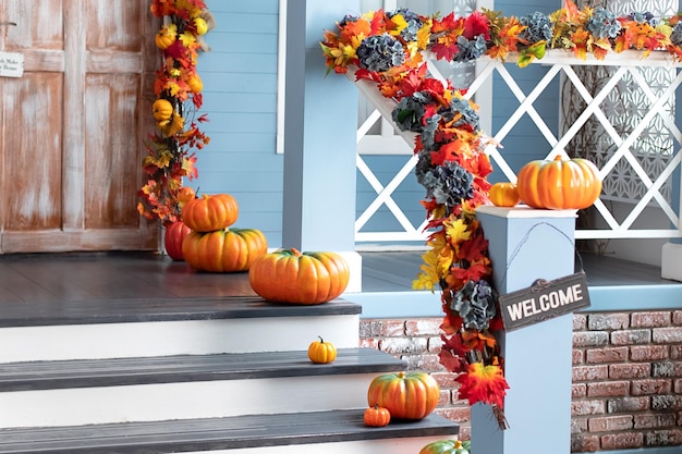 Different colored pumpkins in front door On Wooden Steps, Halloween outside