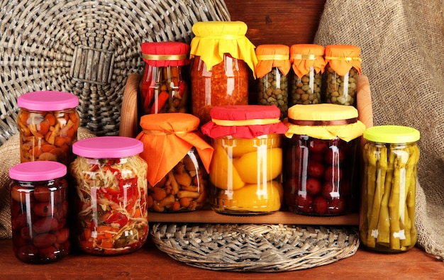 Different conservations on shelves on wooden background