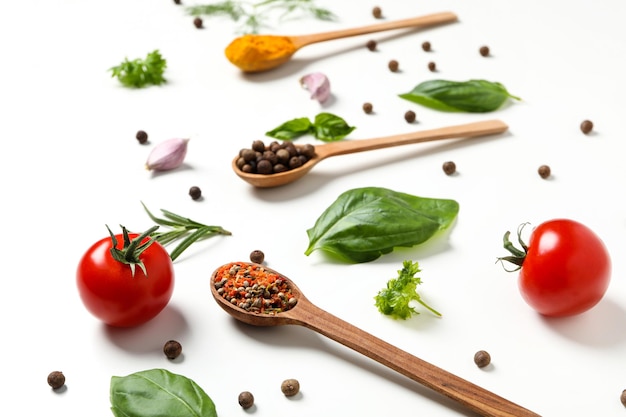 Different cooking ingredients and spices on white background