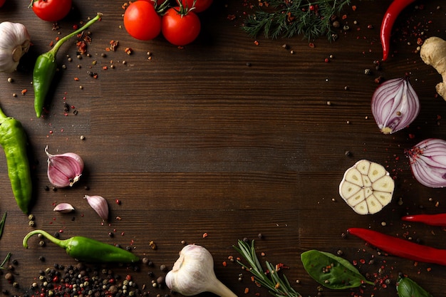 Different cooking ingredients and spices on wooden background