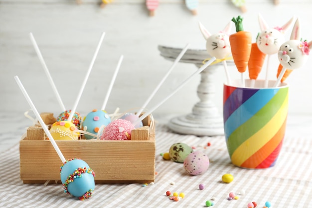 Different delicious sweet cake pops on table Easter holiday