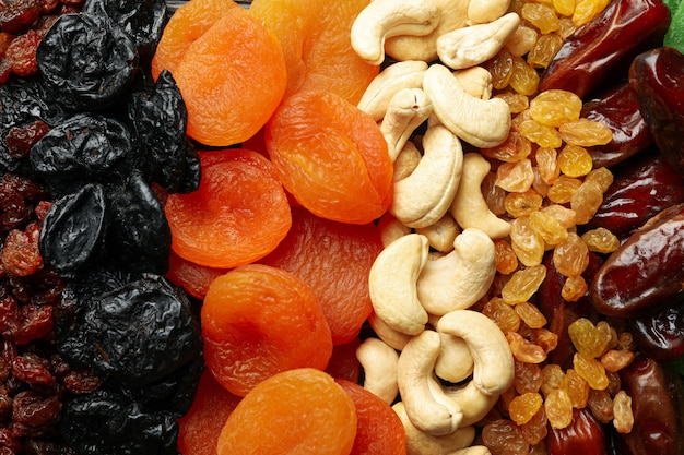 Different dried fruits and nuts on whole background