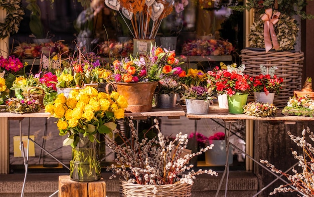 Different flowers and seedlings near the florist flower shop entrance spring time easter concept