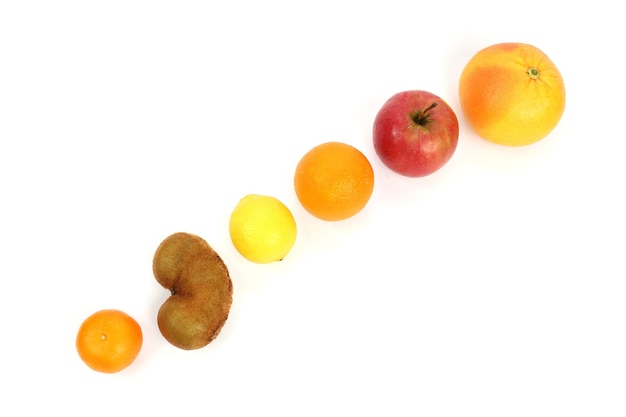 Different fruit on a sloping surface on a white background