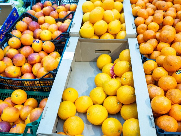 Different fruits on the store counter Trade in fresh fruits A lot of bright fruits in the supermarket