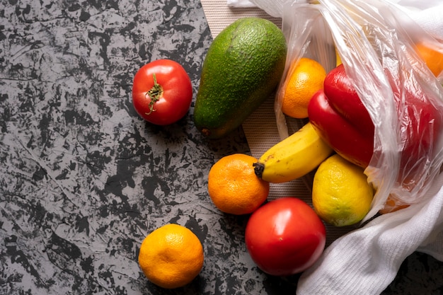 Different fruits and vegetables in a plastic bag, vegetarian and vegan food 