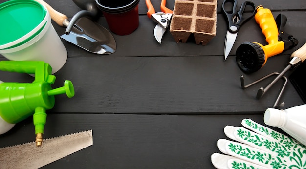 Different gardening tools on a wooden table