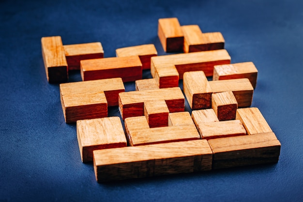 Different geometric shapes wooden blocks on a dark background.