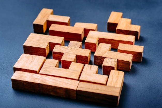 Different geometric shapes wooden blocks on a dark background.