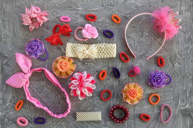 Different hair clips on gray background Flat lay Top view