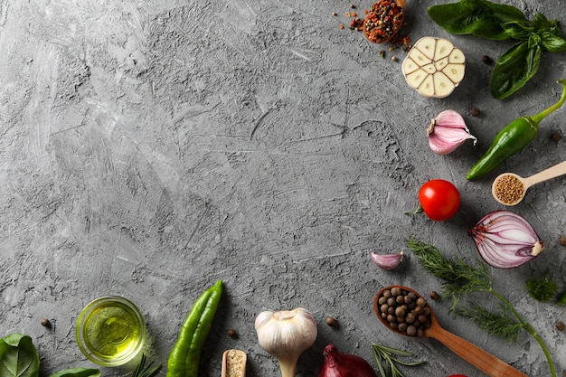 Different ingredients for cooking on gray textured background