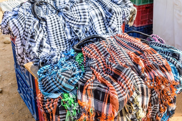 Different keffiyeh traditional arabian headdress for sale in a street shop