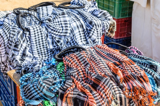 Different keffiyeh traditional arabian headdress for sale in a street shop