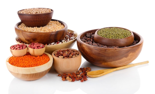 Different kinds of beans in bowls isolated on white