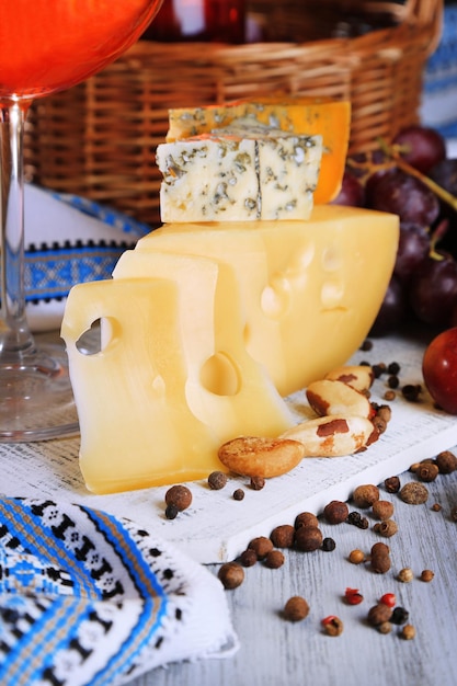 Different kinds of cheese with wine on table closeup