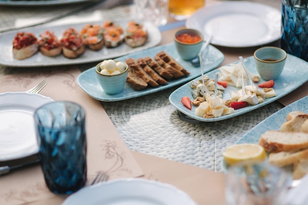 Different kinds of cheeses on served table at summer terrace in cafe food concept different kind of