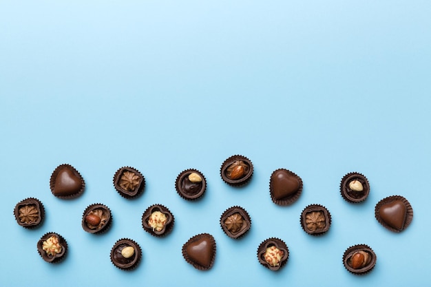 Different kinds of chocolates on colored table closeup Top View and Flat Lay with copy space