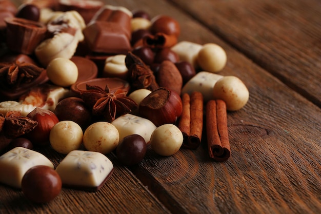 Different kinds of chocolates on wooden table close-up