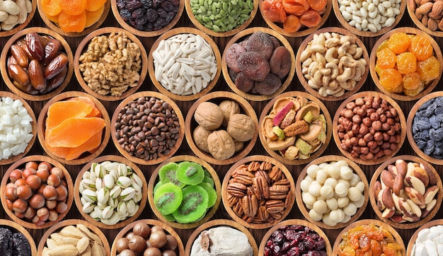 Different kinds dried fruits and nuts background colorful food healthy snacks