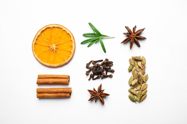 Different mulled wine ingredients on white background flat lay