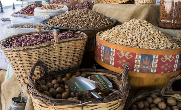 Different nuts in large wicker baskets at the bazaar in Turkey.