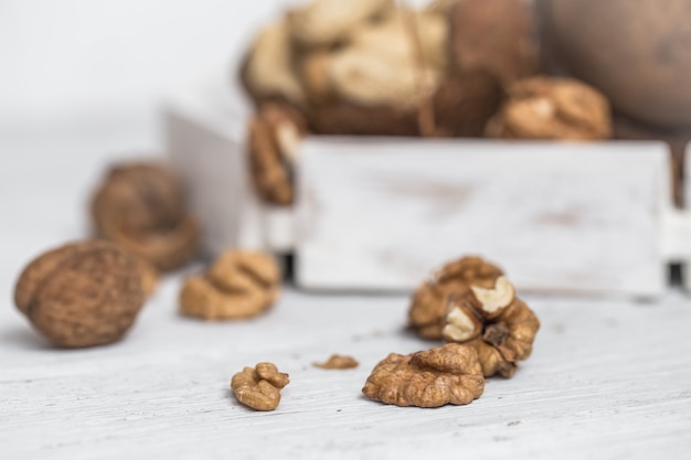 Different nuts on white wooden surface