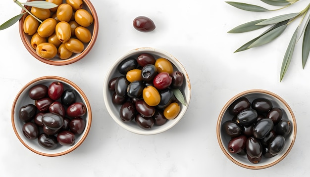 Photo different olives in bowls on white concrete background top view of olives olive leaves diet food