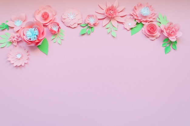 Different pink paper flowers on pink