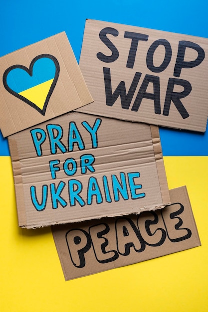 Different posters against the war between Russia and Ukraine on the Ukrainian flag