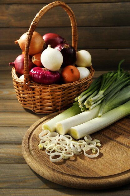 Different raw onion on wooden background