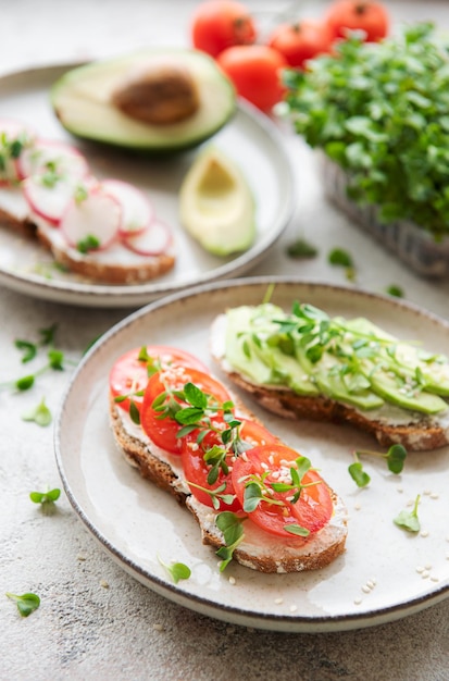 Different sandwiches with vegetables and microgreens