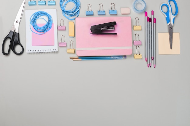 Different school supplies on light grey background