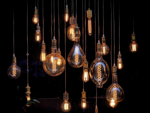 Different shaped vintage light bulbs on black background