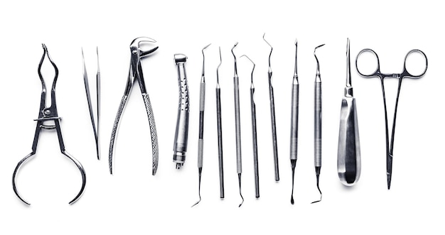 Different shiny metal medical tools isolated on white background