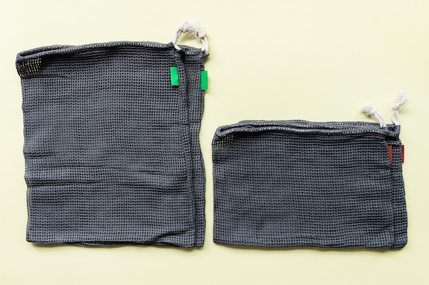 Different sizes of gray mesh eco bags for shopping fruits and vegetables