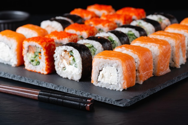 Different sushi rolls on a black background